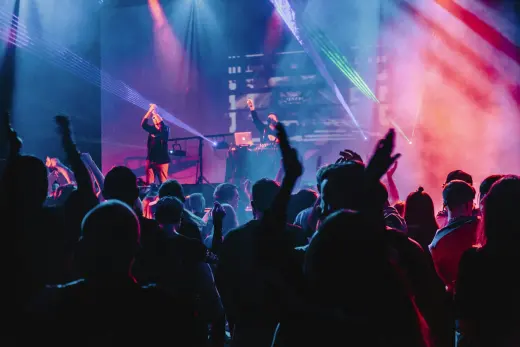 A crowd with hands raised at a live show