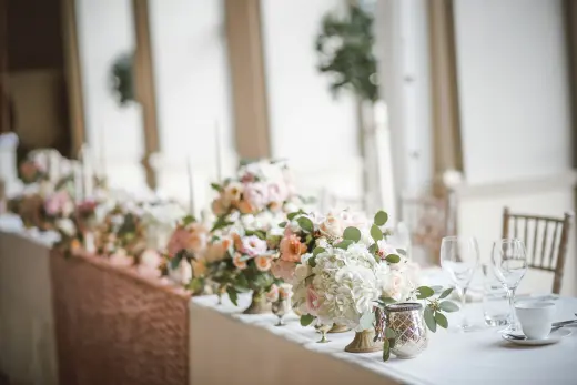 A head table set with florals and candles
